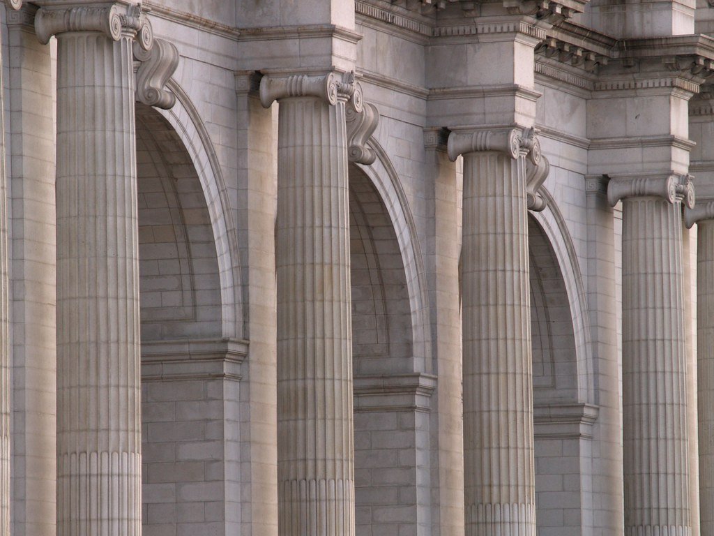 Classical stone columns and arches on a government building facade
